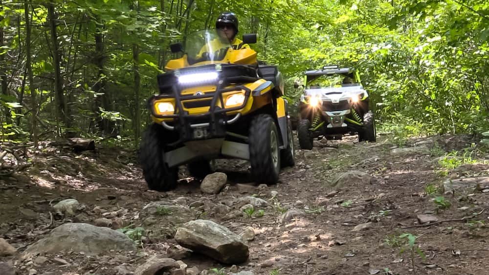 ATV's riding on a trail near campground