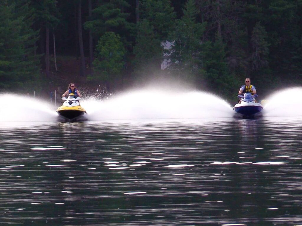 two jet skis speeding across the water