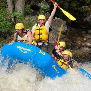 Rafting down the rapids on the Ottawa River in a Wilderness Tours raft